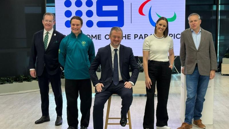 Five people pose for a photo